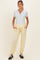 woman wearing a light gray maternity henley top and yellow maternity jogger pants with pockets