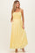 woman wearing a yellow maternity maxi dress with smocked bodice and pockets
