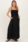 woman wearing a black maternity maxi dress with smocked bodice and pockets