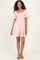 woman wearing a pink and white striped short dress with a smocked bodice and lace-trimmed sleeves and hem