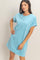 woman wearing a light blue short sleeve t-shirt dress with a chest pocket and a relaxed fit