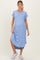 woman wearing a light blue ribbed maternity dress with short sleeves and side slits, showing her baby bump
