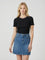 woman wearing a black short sleeve top with a red and white collar and a blue denim mini skirt