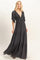 woman wearing a black maxi dress with flutter sleeves and a deep v-neck, featuring a tiered skirt design