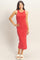 woman wearing a red tank dress with a fitted silhouette and side slits, standing in white slide sandals
