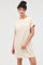 woman wearing a cream and beige striped t-shirt dress with a pocket and rolled sleeves
