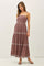 woman wearing a mauve maxi dress with spaghetti straps and floral embroidery, standing and modeling the dress