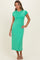 woman wearing a green short sleeve midi dress with a fitted silhouette and colorful trim details