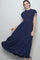 woman wearing a navy blue tiered maxi dress with short flutter sleeves and a smocked bodice