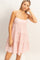 woman wearing a pink and white striped tiered sundress with spaghetti straps