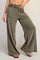 woman wearing olive green wide-leg lounge pants with an elastic waistband and side pockets