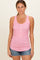 woman wearing a pink sleeveless tank top with a floral pattern and button details, paired with denim shorts