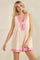 woman wearing a floral sleeveless nightgown with a v-neck and pink trim