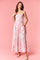 woman wearing a pink floral maxi dress with adjustable straps and pockets
