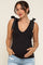woman wearing a black maternity tank top with bow tie straps and a visible baby bump