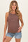 woman wearing a striped brown and cream maternity tank top with a baby bump, paired with denim shorts
