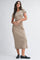 woman wearing a tan short sleeve midi dress with a relaxed fit and black loafers