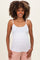 woman wearing a white maternity tank top with spaghetti straps and a slight baby bump visible