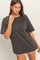 woman wearing a gray oversized t-shirt with short sleeves and distressed hemline