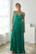 woman wearing a green maxi dress with a spaghetti strap and dotted pattern