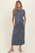 woman wearing a navy and white striped maternity maxi dress with pockets and a tie detail, showcasing her baby bump