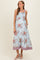 woman wearing a blue floral maternity maxi dress with smocked bodice and pockets