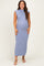 woman wearing a form-fitting light blue ribbed maternity maxi dress, showing off her baby bump