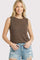 woman wearing a brown sleeveless top and distressed denim shorts