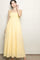 woman wearing a yellow maxi dress with a smocked bodice and adjustable straps