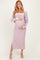 woman wearing a lavender ribbed maternity dress with side slits and a white trim, holding her baby bump
