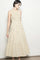 woman wearing a cream tiered maxi dress with brown polka dots and a sleeveless design