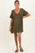 woman wearing an olive green maternity dress with short sleeves and a V-neck, slightly showing a baby bump