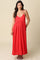 woman wearing a red spaghetti strap maxi dress with a fitted bodice and flowy skirt