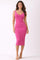 woman wearing a fitted pink ribbed midi dress with a scoop neckline and spaghetti straps