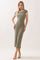 woman wearing a fitted olive green midi dress with white trim and short sleeves, standing in a relaxed pose