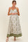 woman wearing a floral green and white maternity maxi dress with a tie halter neckline and a flowing skirt