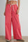woman wearing red checkered wide-leg pants with elastic waist and drawstring