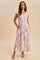 woman wearing a floral print long maxi dress with short ruffle sleeves and pockets