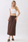 woman wearing a white crop top and a brown maxi skirt with a drawstring waist