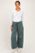 woman wearing a white long sleeve fitted top and green wide leg maternity joggers with an elastic waistband