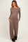 woman wearing a brown long sleeve maternity top with buttons and matching wide-leg pants, showing her baby bump