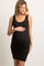 woman wearing a black ribbed maternity dress, showing her baby bump and smiling