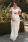 pregnant woman in white floral lace maternity dress holding a bouquet of pink roses