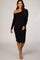 woman wearing a fitted black long sleeve off-shoulder dress with a midi length