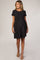 woman wearing a black striped short sleeve maternity dress with an empire waist and flowing skirt