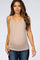 woman wearing a beige maternity tank top and showing her baby bump