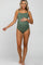 woman wearing a dark green maternity swimsuit with ruched detailing and a visible baby bump