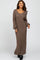 woman wearing a brown ribbed knit maxi dress with long sleeves and a scoop neckline
