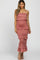 woman wearing a dusty rose midi dress with ruffle tiers and spaghetti straps