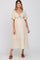 woman wearing a cream maternity dress with short flutter sleeves and a knotted front detail, showing her baby bump